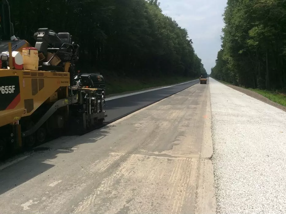 An image of a roadway surface being prepared for an overlay solution to be applied.